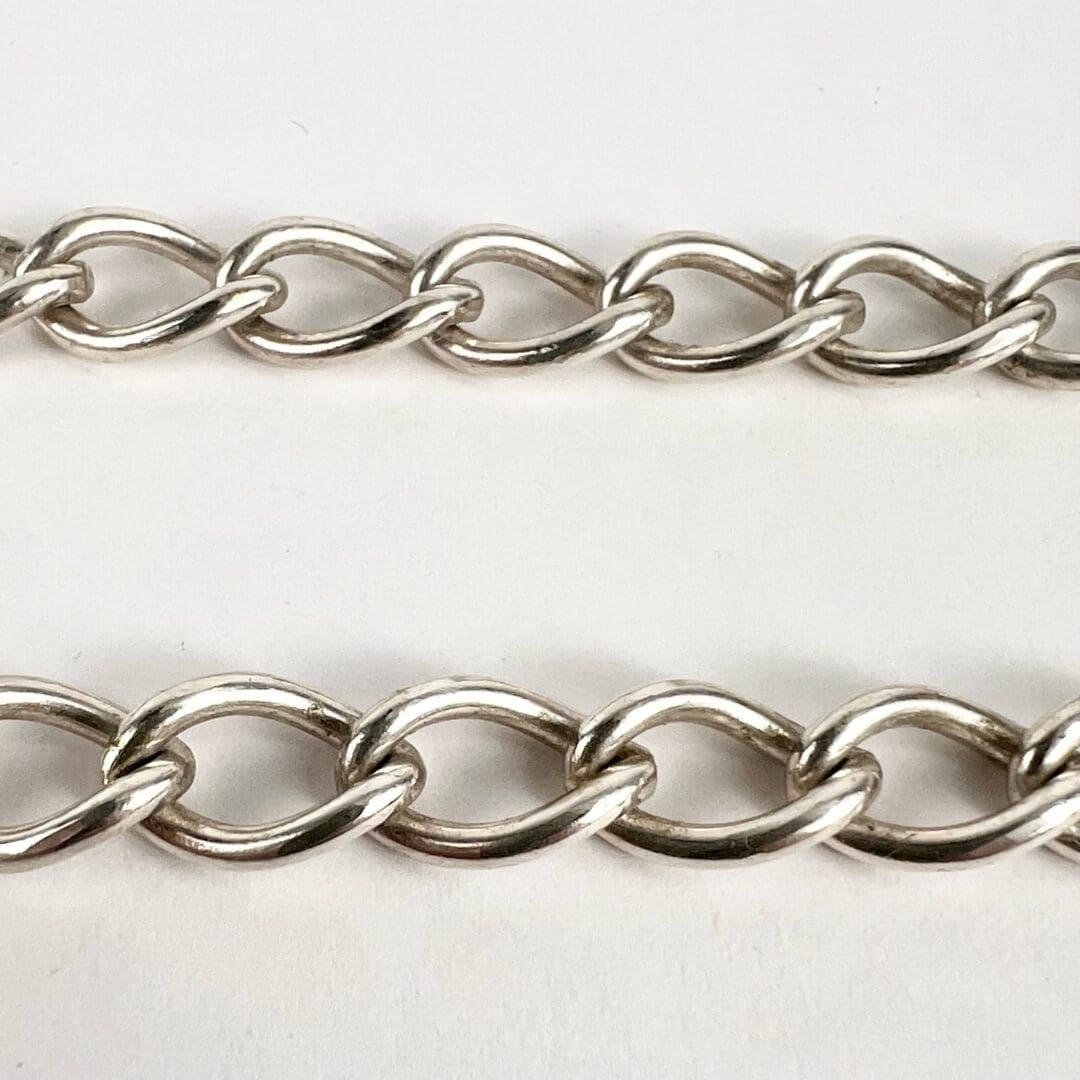 Silver chain links on white background.