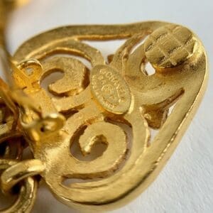 Gold ornate vintage clip-on earring detail.