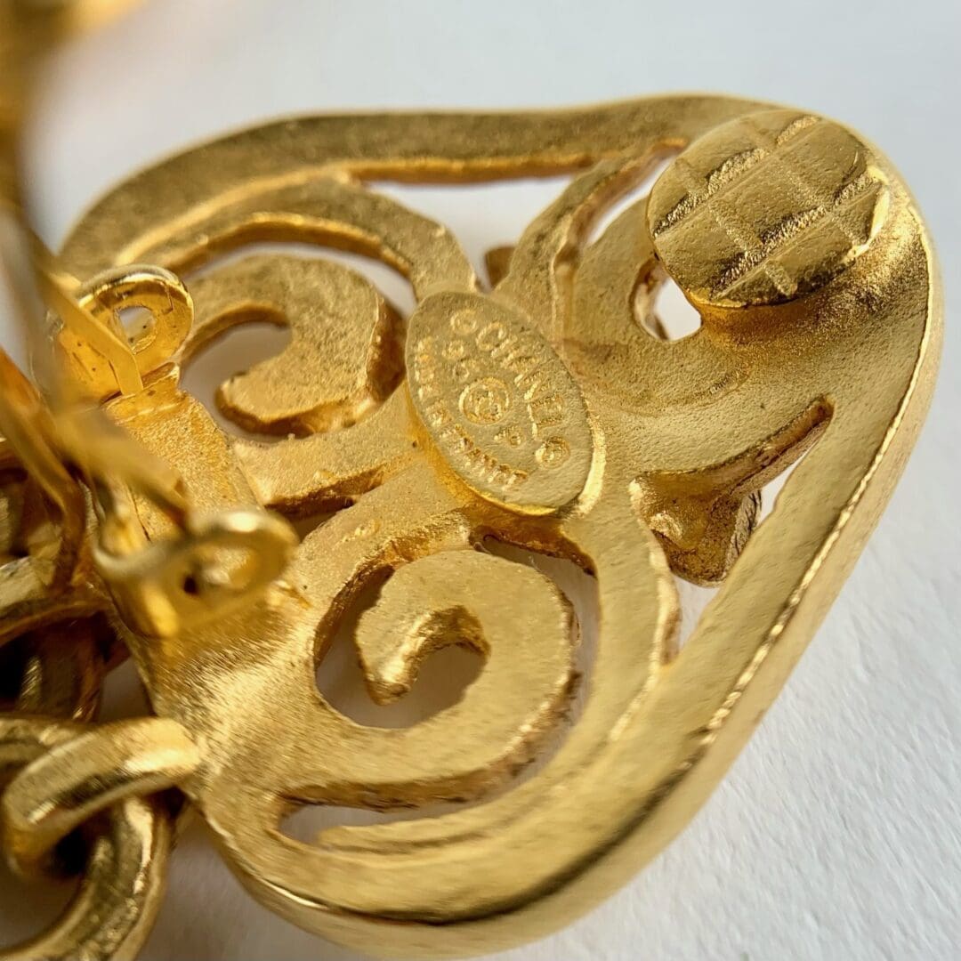 Gold ornate vintage clip-on earring detail.