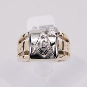 Gold ring with Masonic symbol and diamond.