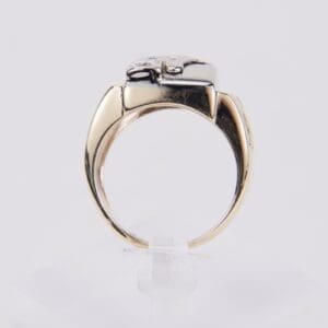 Gold ring with silver detailing, side view.