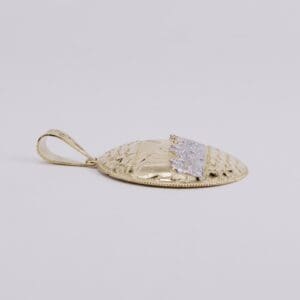 Gold textured pendant with decorative pattern.