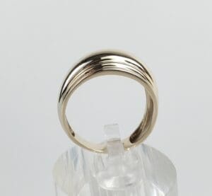 Gold ring on clear display stand.