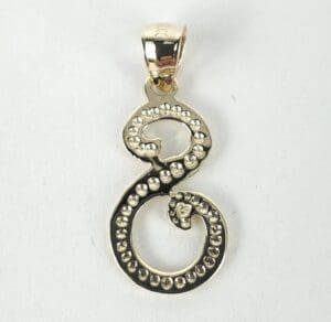 Gold pendant shaped like number eight.