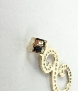 Gold earring with 10K stamp detail.