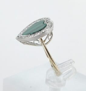 Heart-shaped ring with green gemstone.