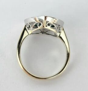 Gold and silver ring with intricate design.
