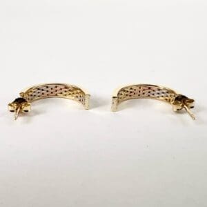 Gold hoop earrings with woven pattern.