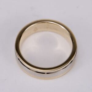 Gold and silver wedding band on display.