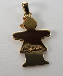 Gold pendant shaped like a person.