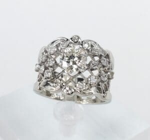 Ornate silver ring with central diamond.
