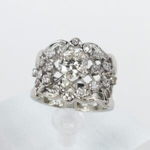 Ornate silver ring with central diamond.