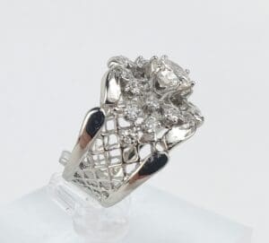 Silver ring with intricate diamond design.