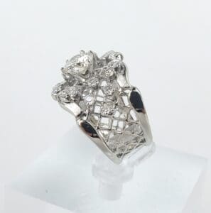 Diamond-encrusted ring with intricate metal design.