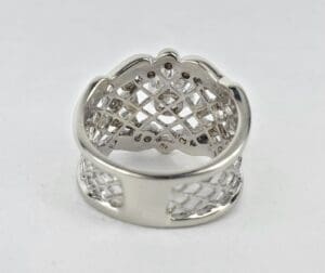 Silver ring with lattice design on white background.