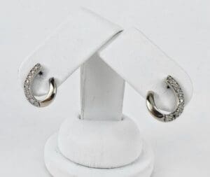 Silver earrings with small embedded stones.