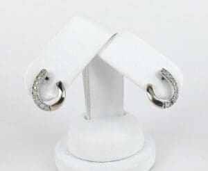 Silver earrings with embedded small diamonds.