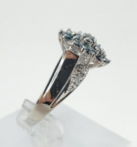 Silver ring with blue and clear stones.