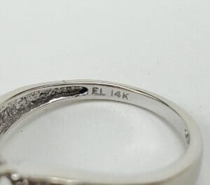 Close-up of ring with "14K" engraving.