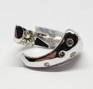 Silver ring with embedded diamonds.