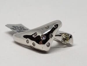 Silver ring with diamond embellishments on display.