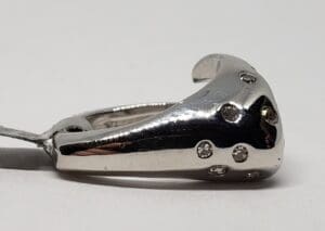 Silver ring with embedded small diamonds.