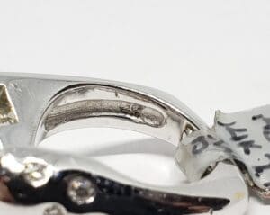 Close-up of a silver ring's inner band.