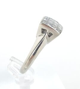 Silver ring with square diamond setting.