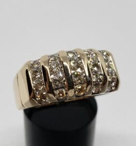 Gold ring with multiple diamond rows.