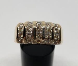 Gold ring with embedded diamonds on display.