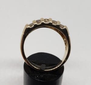 Gold ring with small diamonds on top.