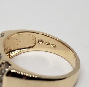 Gold ring with engravings and small diamonds.