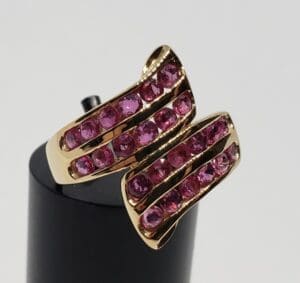 Gold ring with pink gemstones.