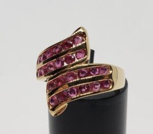 Gold ring with pink gemstones.