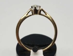Gold ring with a diamond solitaire setting.