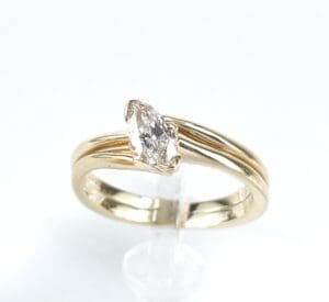 Gold ring with marquise diamond setting.