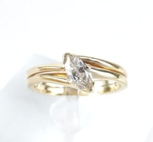 Gold ring with marquise-cut diamond stone.