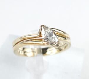 Gold ring with marquise diamond solitaire.