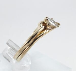 Gold ring with a single diamond setting.