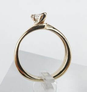 Gold ring with a diamond solitaire setting.