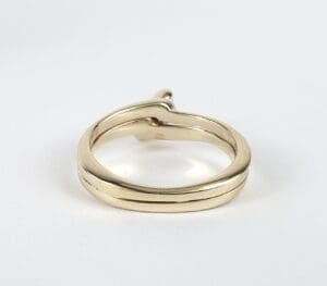 Gold ring with a heart-shaped design.