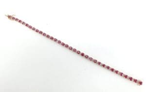 Ruby gemstone bracelet on white background.