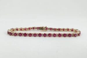 Gold bracelet with red gemstones.