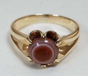 Gold ring with round striped stone.