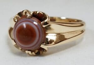 Gold ring with brown striped gemstone.