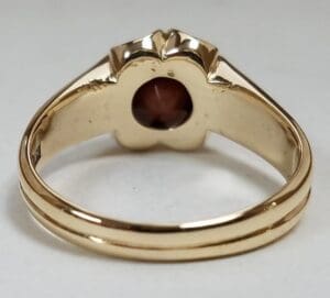 Gold ring with a gemstone setting.