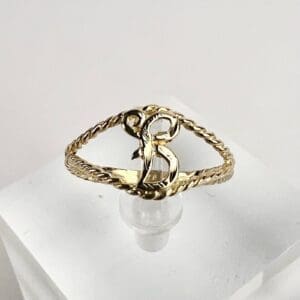 Gold ring with letter B design.