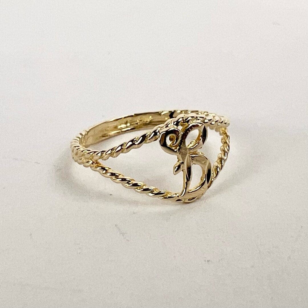 Gold ring with decorative twisted band.