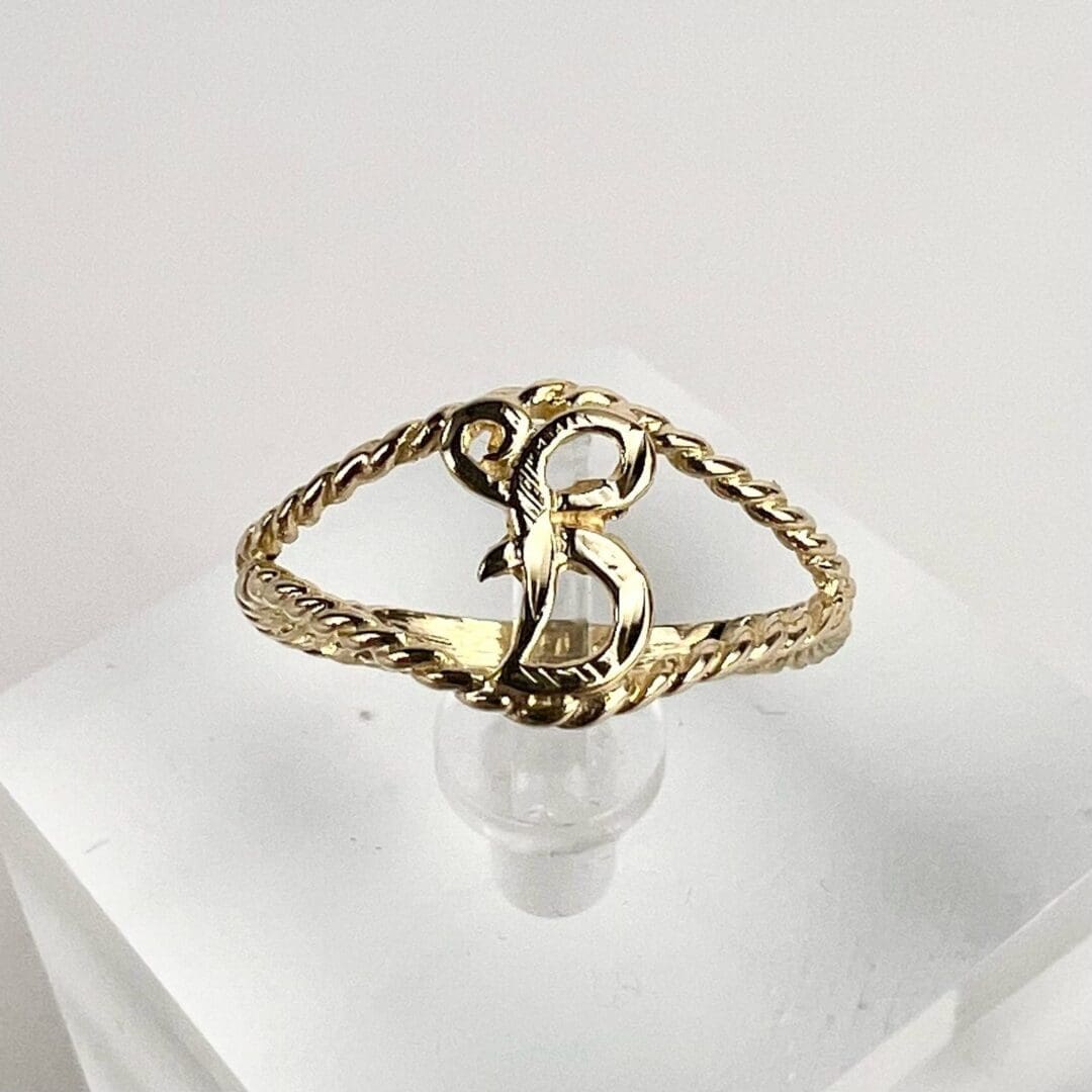 Gold ring with letter B design.