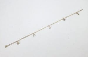 Gold charm bracelet with multiple pendants.